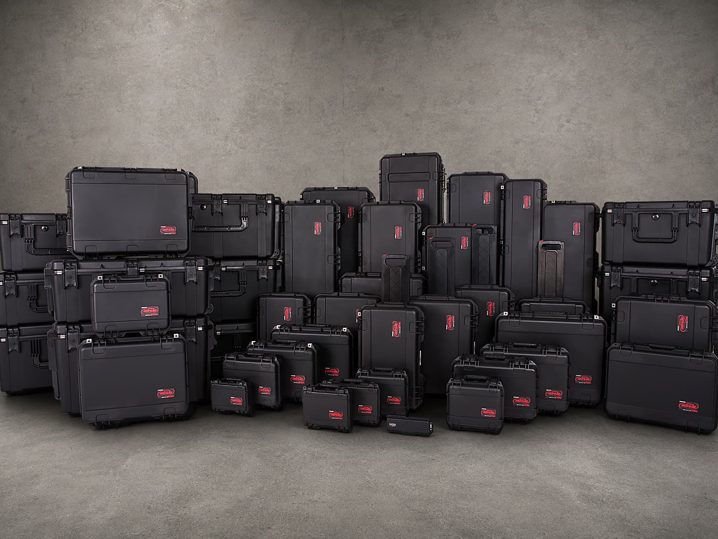 A full lineup of black SKB hard sided transport cases in a range of sizes