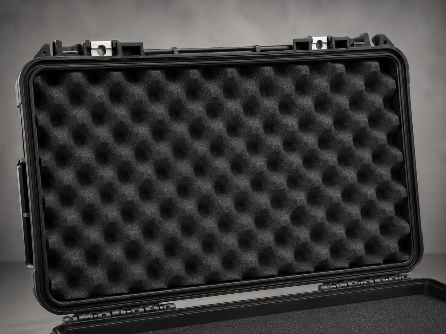 A protective case lid lined with black convoluted foam