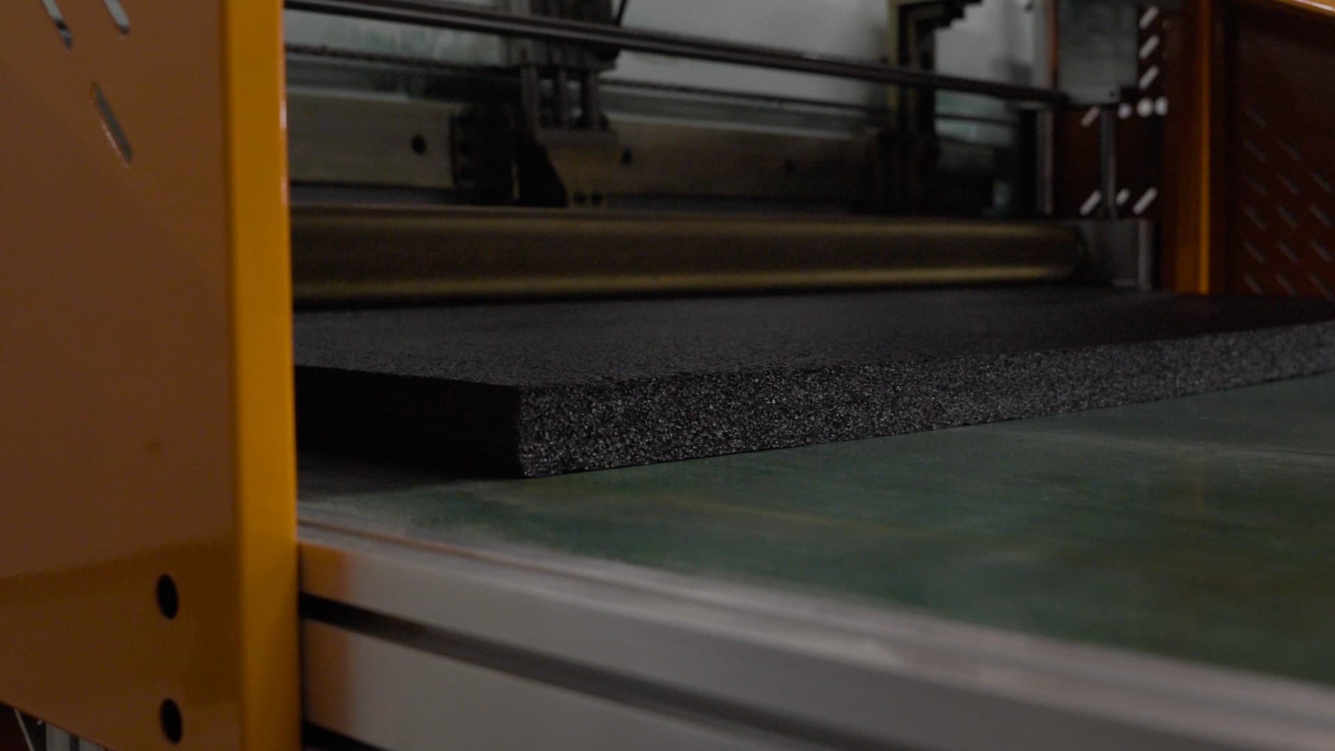 Foam being cut on the FoamCraft shop floor, leaving usable offcuts