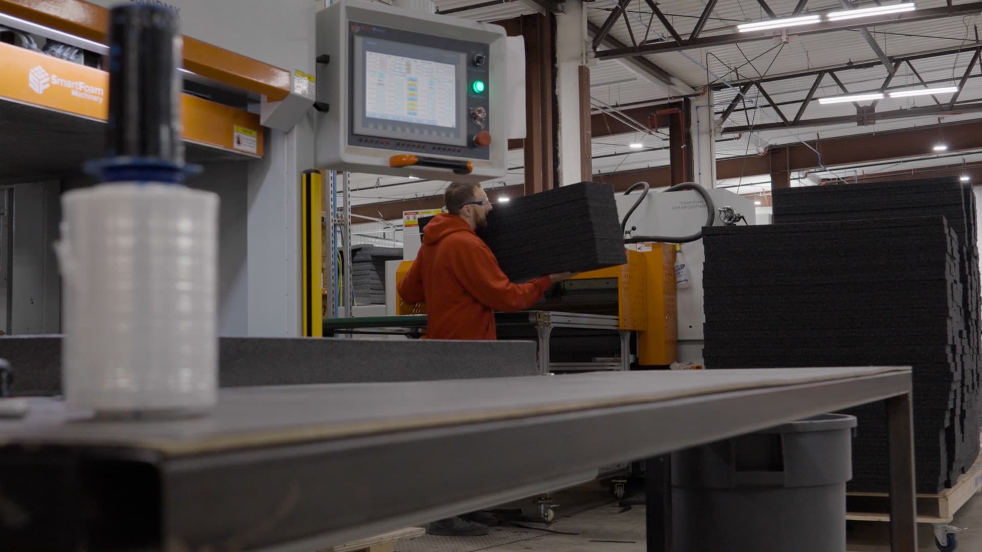 A FoamCraft team member moving foam through the fabrication shop