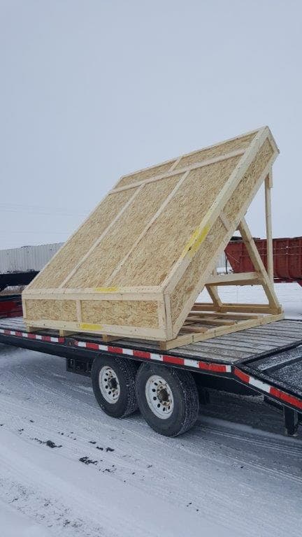 A large crate secured on a trailer