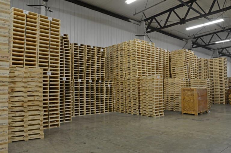 Stacks of finished wood pallets filling the FoamCraft warehouse